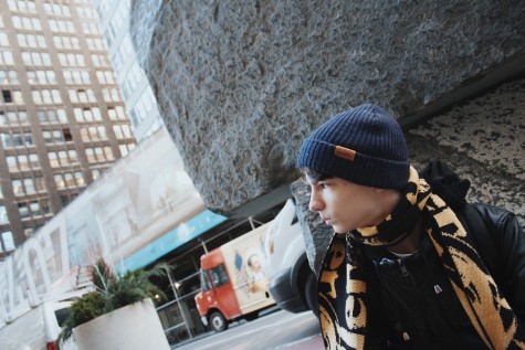 Nick Lux sits by a boulder in New York, hopeful for the future.