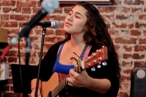 Junior Gabriella Mammia performs a few of her original songs at an open mic at Kettle Coffee & Tea. Mammia has been a regular of Kettle for quite some time and frequently performs at the Open Mic. 