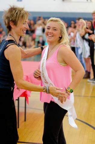 Avalon Johnson receives a "Homecoming Court" sash after her nomination as homecoming queen on September 26. Johnson joined her sister Sidney, who won sophomore homecoming princess, as a member of homecoming court. "When I saw my sister got [sophomore princess], I thought my mom was there for her," said Johnson. "Then when I got it, I was like 'oh my gosh, this is the only year we'll be in court together.' It was super special." Photo taken by Michaela Sanderson.