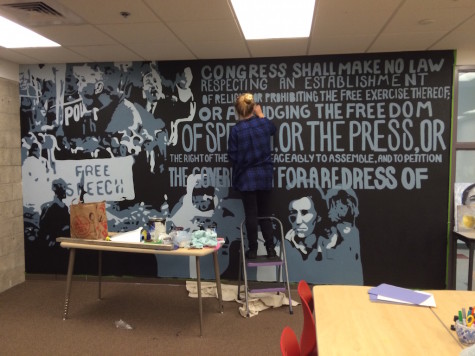 Rogers puts the finishing touches on her mural. She plans on completing the wall by June 5.
