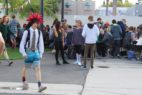 Junior Trevor McAdams walks during lunch wearing board shorts and a shirt and tie, completing the look with a silly hat.