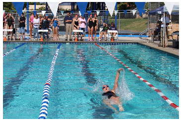 Vukovics pushes through a lap at a swim meet. 