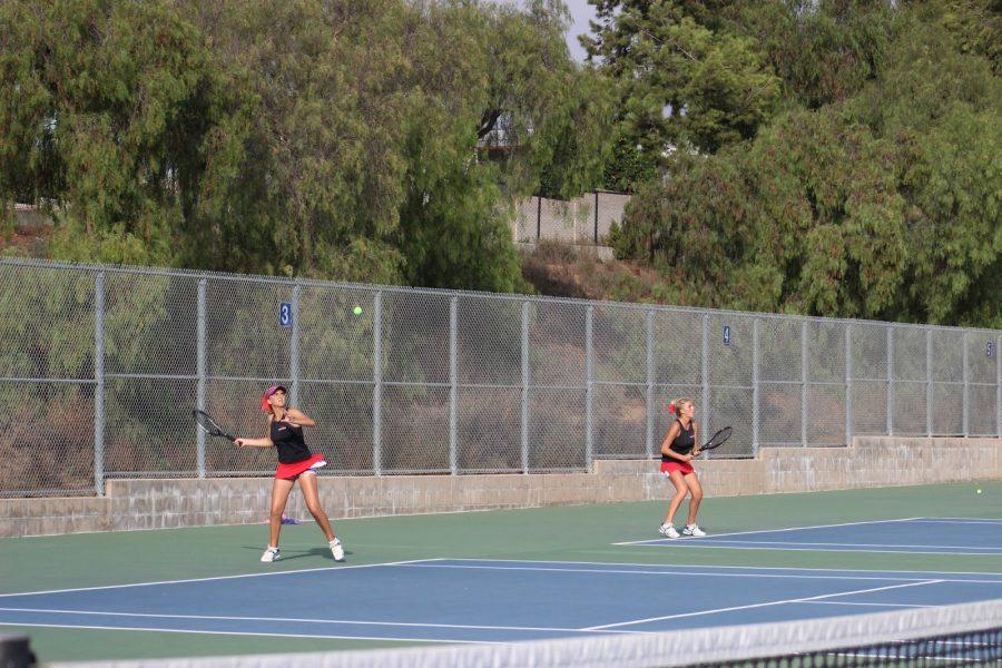 A Sibling Match. Sisters Lexie and Taylee Mann-Shomo play intense matches on courts next to one another. Photo taken by Lauryn Butler. 