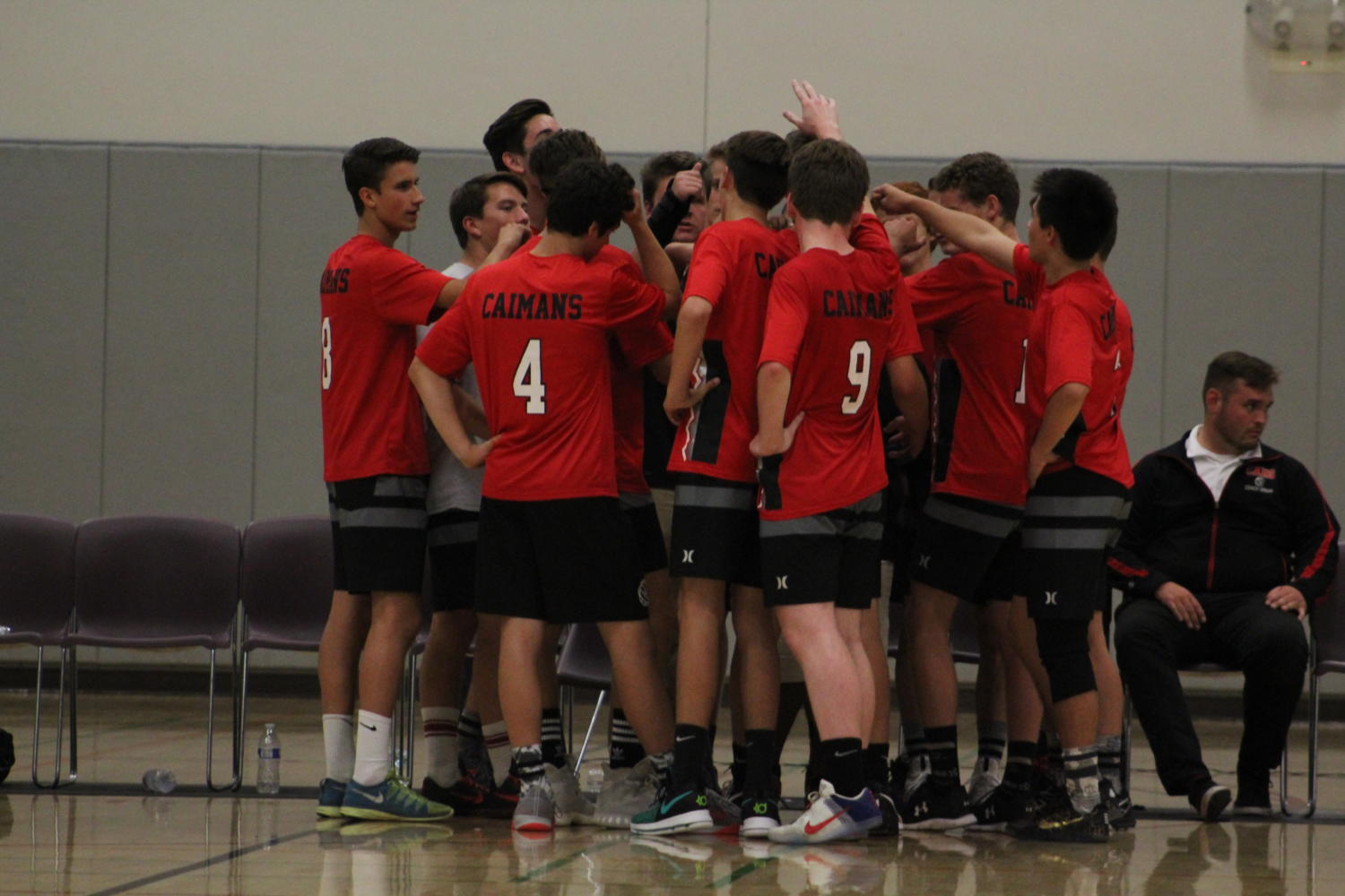 The team huddles up before heading out onto the court. Photo taken by Aubrey Gehman.