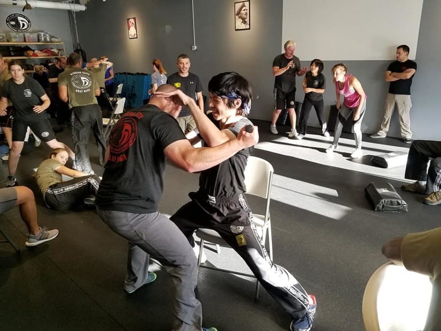 Choy grapples with a partner at his krav gym. 